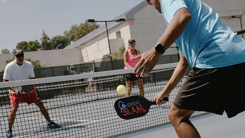 A group of people enjoying a game of pickleball.