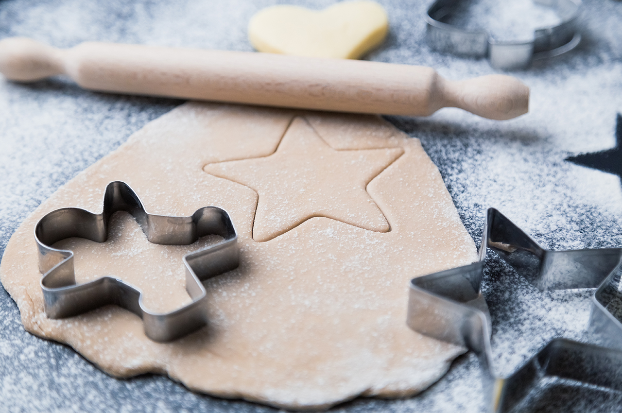 Sugar cookie dough and cookie cutter.