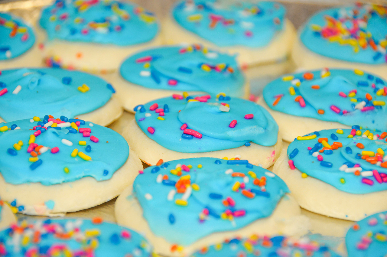 Sugar cookies with blue frosting and spinkles.
